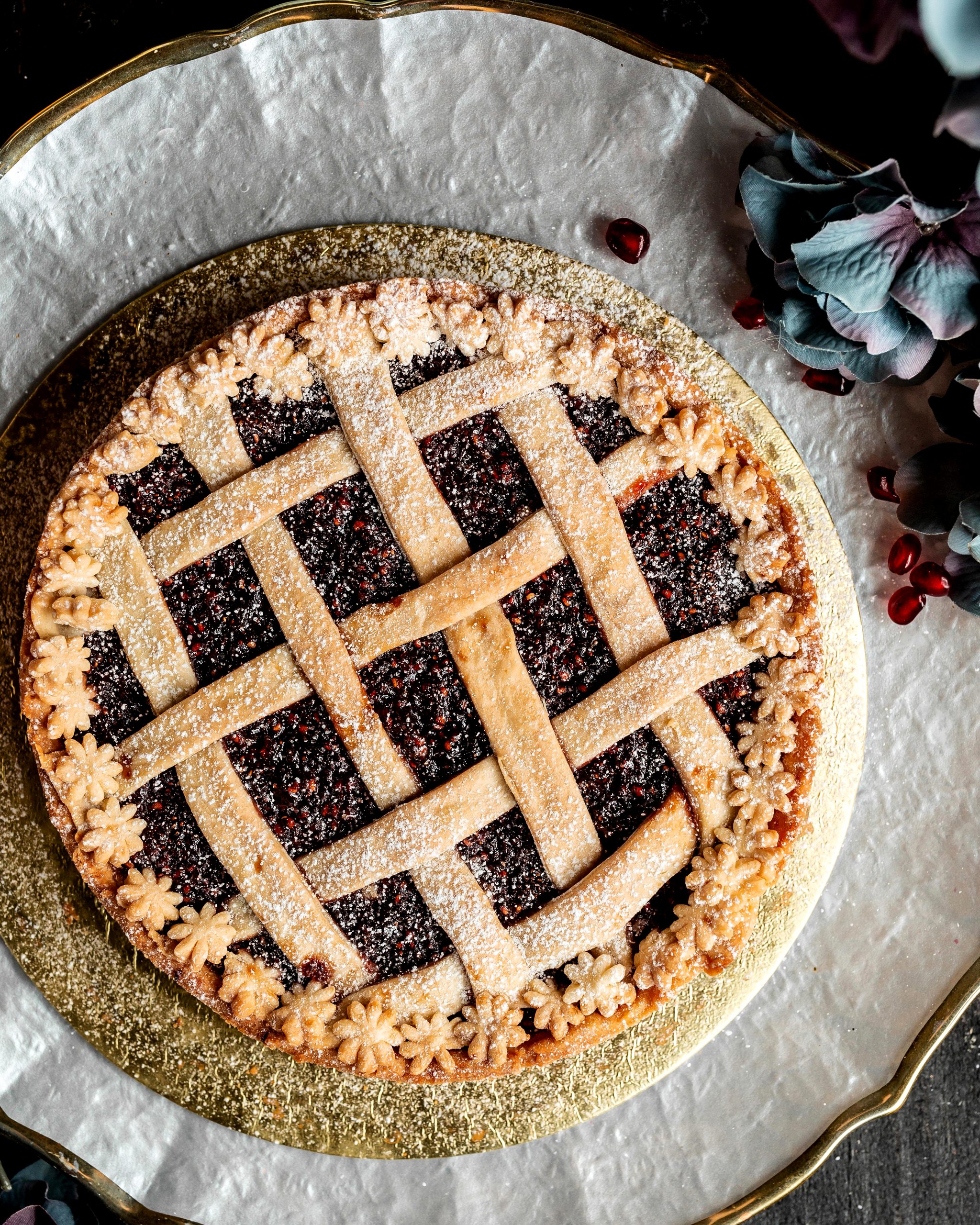 top view of pomegranate pie sprinkled with sugar powder